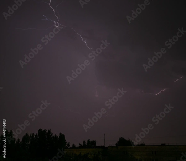 Fototapeta Lightning during a storm over the city in the nightLightning during a storm over the city in the night