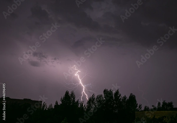 Fototapeta Lightning during a storm over the city in the nightLightning during a storm over the city in the night