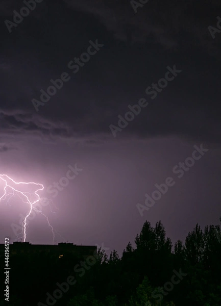 Fototapeta Lightning during a storm over the city in the nightLightning during a storm over the city in the night