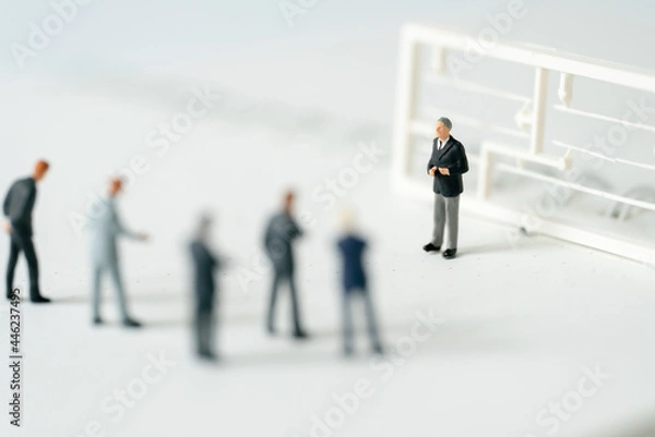 Fototapeta Miniature people A Businessman speech presentation on public stage on white background using as Success Business Due and New Technology products announcement partnership business development concept
