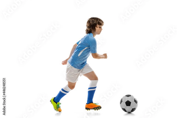 Fototapeta One preschool boy, football soccer player in action, motion training isolated on white studio background. Concept of sport, game, hobby