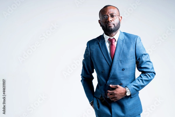 Obraz Serious african businessman in a suit wearing glasses and with a black beard looking at the camera