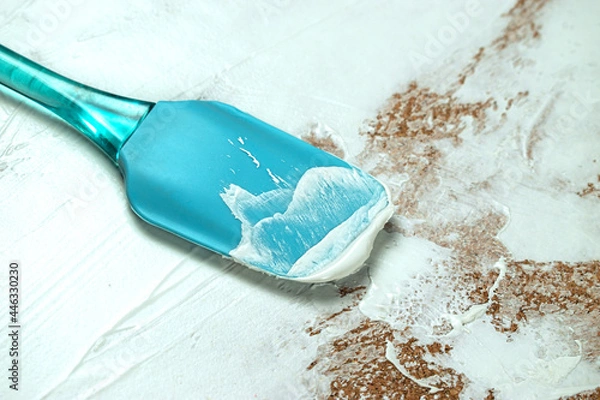 Obraz A man applies white plaster with a spatula