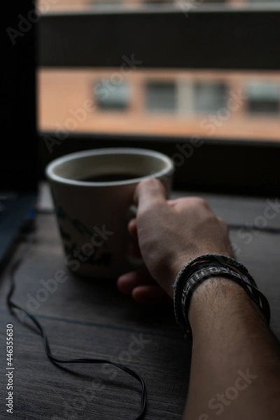 Fototapeta Drinking a coffee on the desk while I'm working