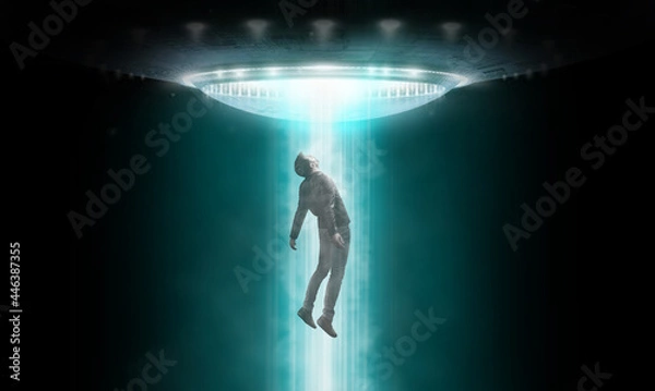 Fototapeta Man being abducted by UFO