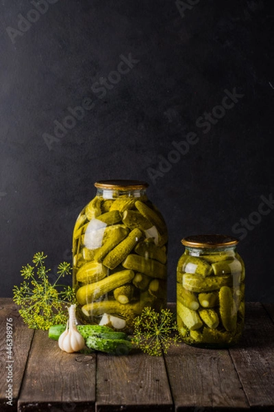 Fototapeta Pickled cucumbers in the jar. Ingredients for pickling cucumbers. Cucumbers, dill, garlic. Glass jars with pickles