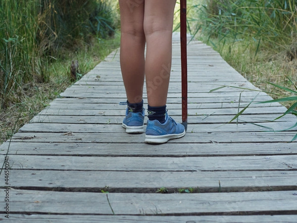 Fototapeta girl feet on field trip in closeap