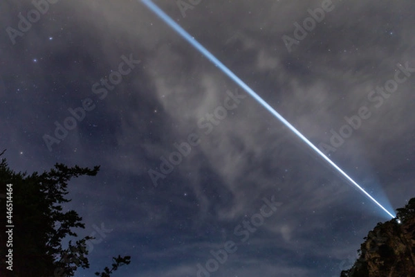 Obraz Laser-like lighthouse light and starry sky