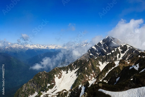 Fototapeta mountain peak with snow and clouds in caucasus mountains