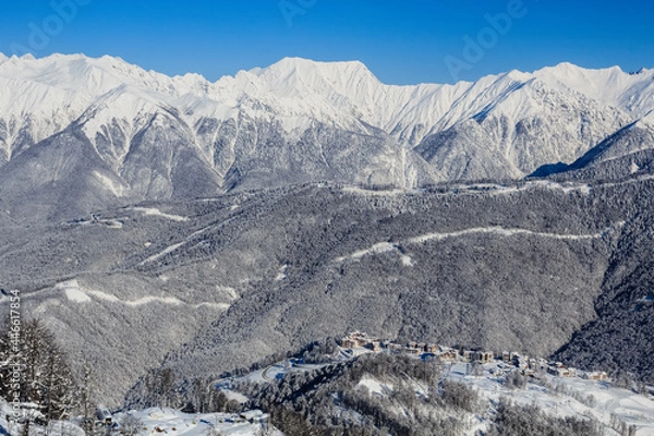 Fototapeta snowy mountain ridge and gorup of the hotels in Rosa Khutor ski resrot Sochi