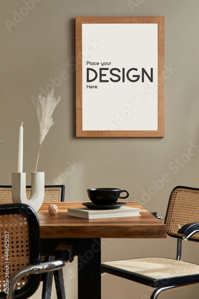 Fototapeta Creative composition of cozy and stylish dining room interior with mock up poster frame, wooden table, chair, black dishes and accessories. Sunny and light space. Neutral colors. Beige walls..