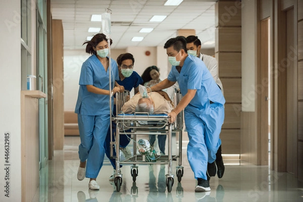 Obraz Emergency Department: Group of Doctors, Nurses, Paramedics Push Gurney, Stretcher with Seriously trauma Patient towards the Operating Room. Group of Asian staff rushing to save the people