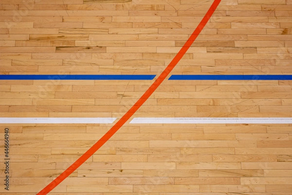 Obraz The worn wooden floor of the sports basketball hall with colorful marking lines.