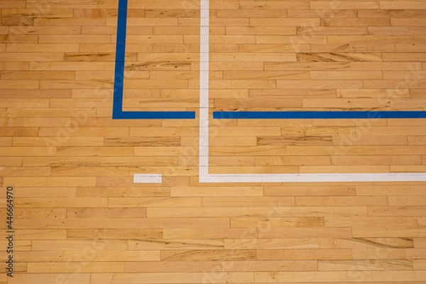 Obraz The worn wooden floor of the sports basketball hall with colorful marking lines.