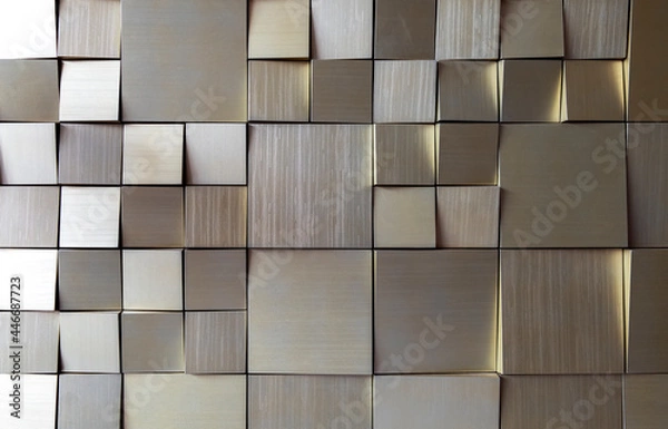 Fototapeta small square gold tiles on the wall. rough surface texture