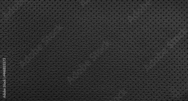 Fototapeta Closeup black leather of interior material for sport car. Modern, luxury and quality element for design decorative. Rough texture background. Pattern wallpaper.