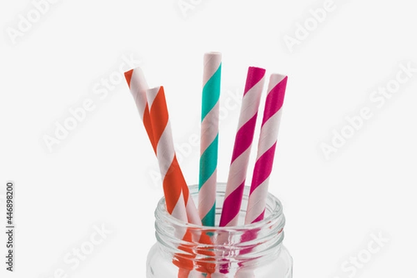 Fototapeta Collection of coloured paper straws in a glass jar isolated on white background, Eco-friendly concept.