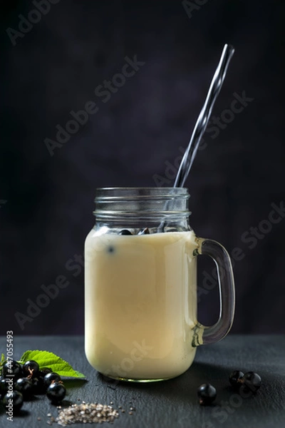 Fototapeta high resolution photo: unmixed black currant smoozie in low key