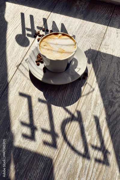Obraz a cup of coffee on the table and coffee beans wi-fi free