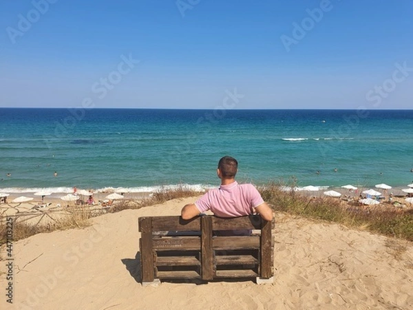 Obraz man sitting on the beach
