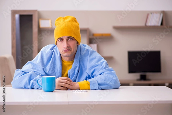 Fototapeta Young man suffering at home