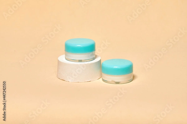 Fototapeta Cosmetics container on the pastel background. Earth colors, zero waste containers. Mockup concept. Minimal boxes and geometric podium. Scene with geometrical forms. 