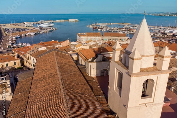 Fototapeta The panorama of Termoli town with the cathedral bell tower in the foreground and the port on the background , Termoli , Italy