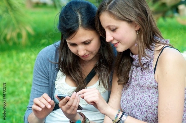 Obraz Two Girls while They speak At the Cellular