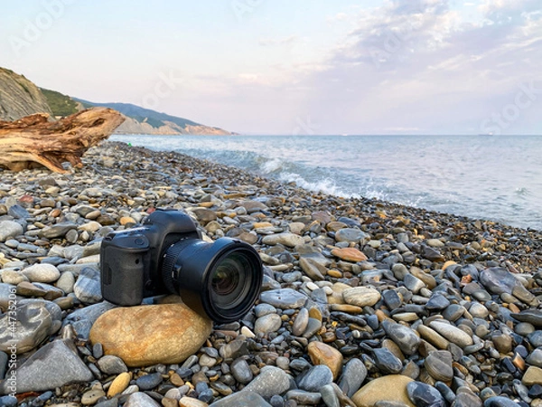Fototapeta DSLR camera on the stone, in background is Black sea and mountains