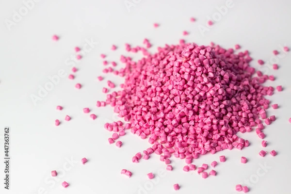 Obraz Pink granules of polypropylene or polyamide on a white background. Plastics and polymers industry. Copy space.