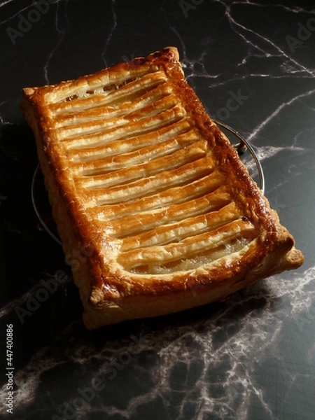 Obraz Rectangular apple pie decorated with a lace puff pastry