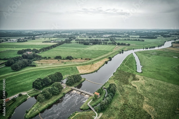 Fototapeta Airial view of a weir in the river Vecht. Dutch river in a colorful landscape. Water authority Drents Delta Overijssel