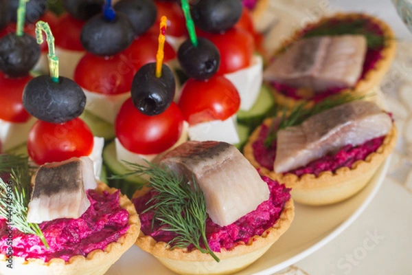 Fototapeta appetizer on the festive table on skewers and in tartlets