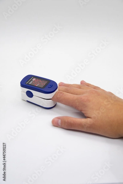 Obraz Hand using oximeter on index finger
