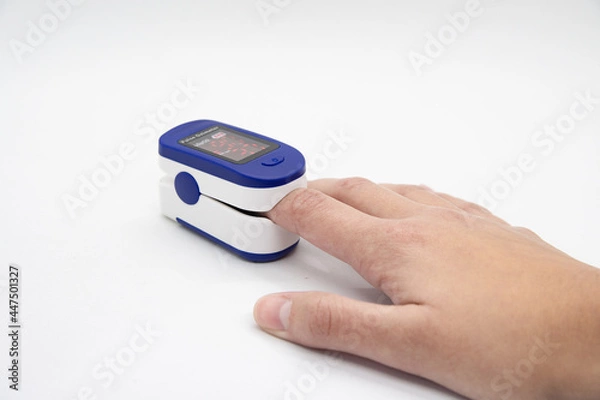 Obraz Hand using oximeter on index finger