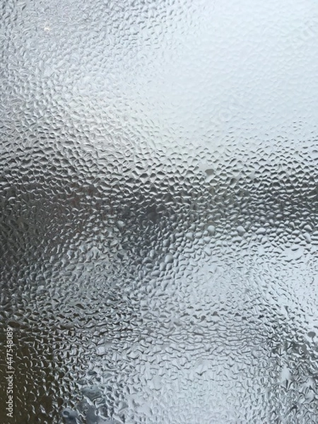 Obraz view from the window wet glass covered with wet flowing water, snow melts