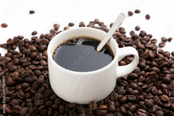 Obraz White coffee mug with spoon on coffee background