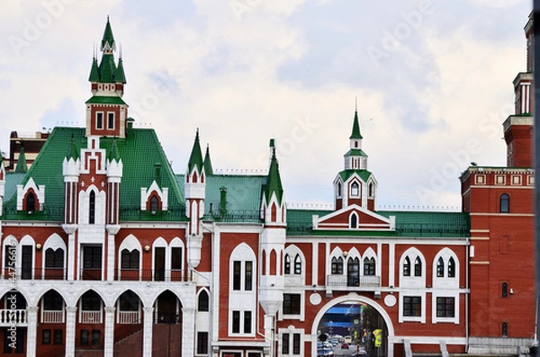 Fototapeta The building is in the Dutch style of red and white brick with a green roof. Russia Yoshkar Ola 01.05.2021. High quality photo