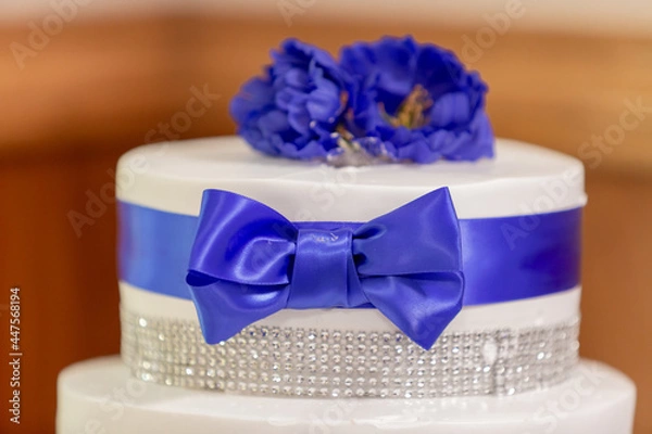 Obraz Wedding Cake with blue  ribbon