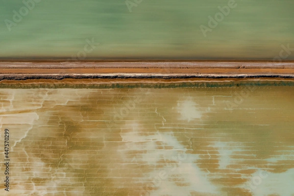 Obraz Abstract aerial view of blue-green water in shifting red deposition of sediment gradually moving through alluvial plains of Francois Peron National Park in Western Australia.