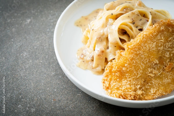 Fototapeta fettuccine pasta white cream sauce with fried fish
