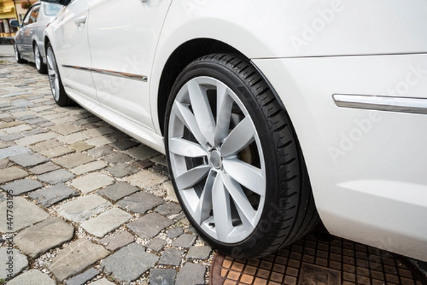 Fototapeta Modern car wheel with a light alloy disc. Low chassis.