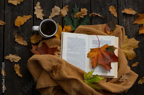 Fototapeta Fallen Leaves, Coffee and Open Book Flat Lay Photo. Autumn Cozy Composition on wooden background. Cup of coffee, book and foliage. Rustic, warm, relax morning concept