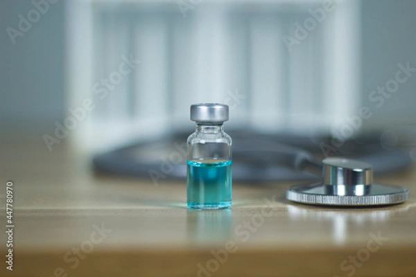 Obraz One bottle of vaccine on the table subcutaneous vaccination Vaccination. Stethoscope health medical concepts, treatment concepts