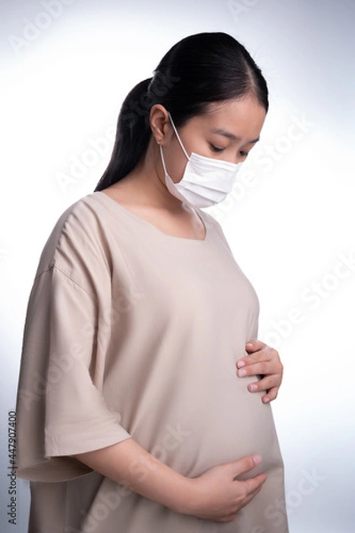 Obraz Pregnant asian woman in medical mask for protect coronavirus (covid-19)