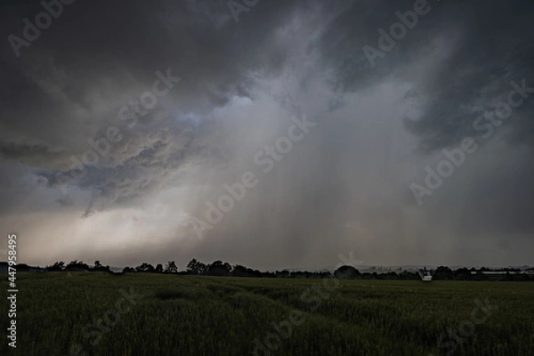 Obraz Storm over Field during climate change wirh rainfall