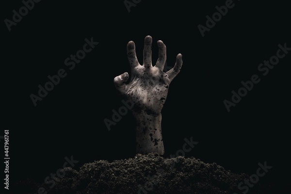 Fototapeta Halloween concept, zombie hand coming out from the grave. Atmosphere of horror.