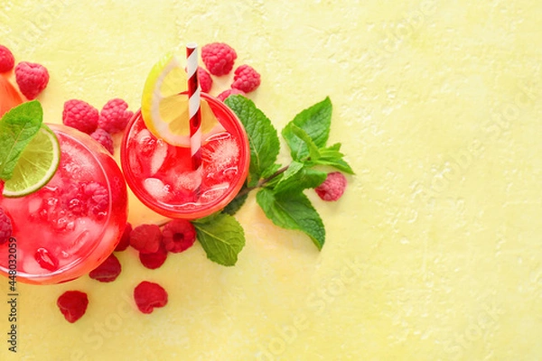 Fototapeta Glasses with tasty raspberry lemonade on color background
