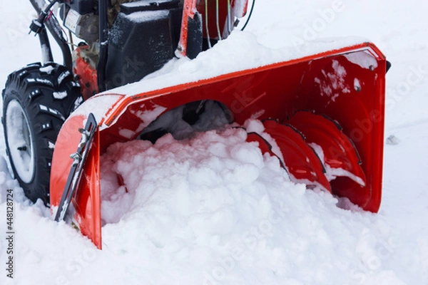 Fototapeta A snow thrower is the best assistant for snow removal in the winter.snow removal with snowplow.abnormal amount of snow