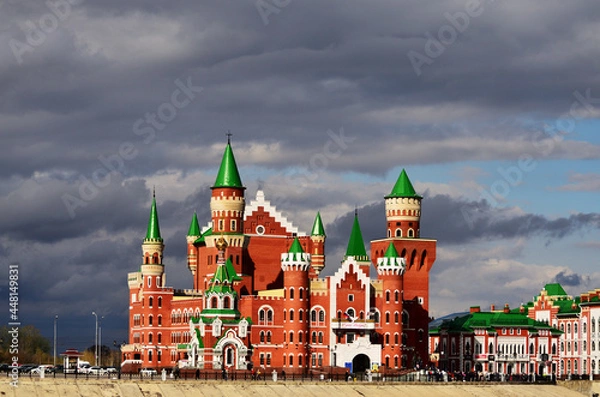 Fototapeta The building of the theater of dolls made of red and white brick in the form of a castle. Russia Yoshkar Ola 01.05.2021. High quality photo